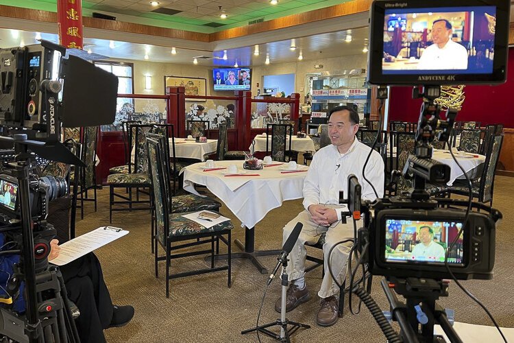 Ed Hom being interviewed at Li Wah